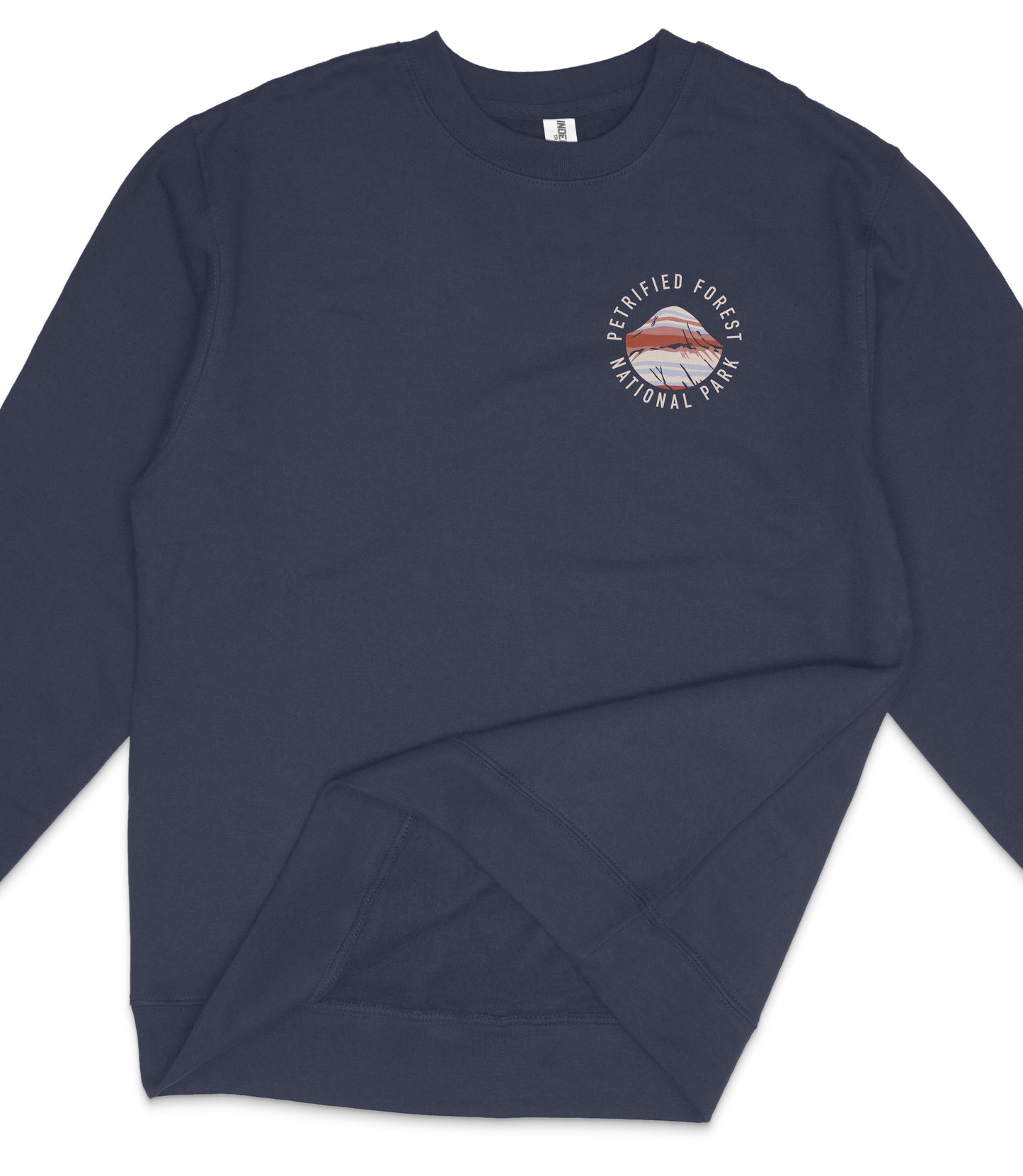 A navy blue long-sleeved shirt with a round logo on the left side, which appears to be a design or emblem related to a protected forest or national park.