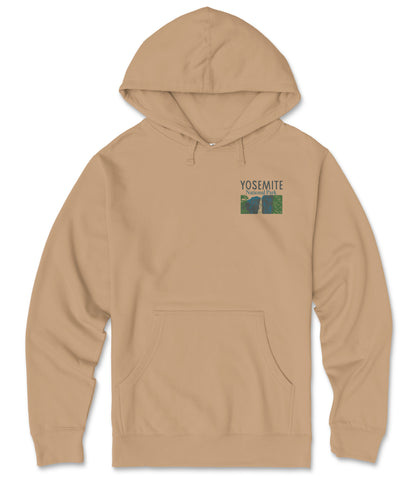 A beige hooded sweatshirt with a graphic design on the front, featuring a mountain landscape and the text "YOSEMITE" printed on it.