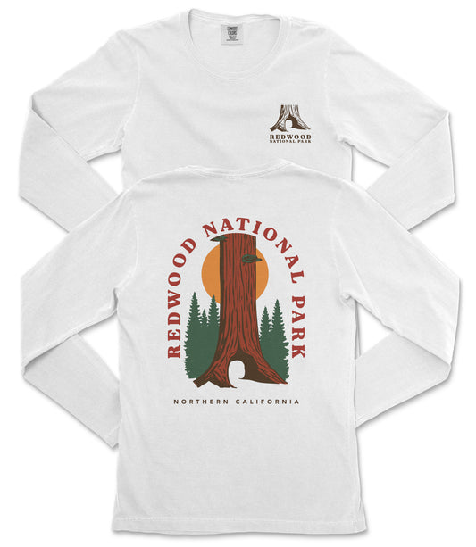 a white long-sleeved t-shirt with a graphic design depicting a redwood tree and the text "REDWOOD NATIONAL PARK NORTHERN CALIFORNIA".