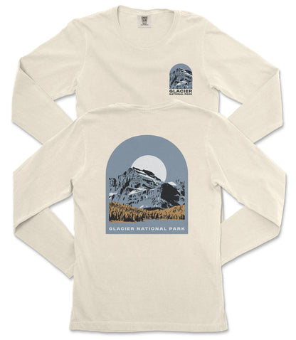 A cream-colored long-sleeved t-shirt with a graphic design depicting a mountain landscape and the text "Glacier National Park" printed on it.