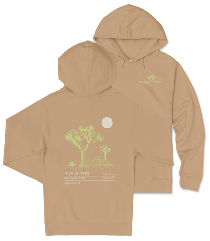 a beige hoodie with a graphic design depicting a desert landscape, including a tree and a moon. The hoodie has a hood and a front pocket.
