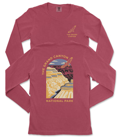 a red long-sleeved t-shirt with a graphic design depicting the Grand Canyon.