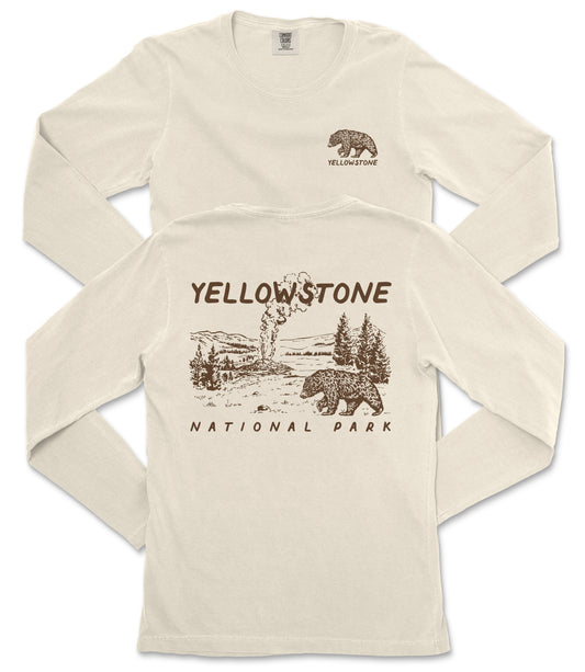 A cream-colored long-sleeved t-shirt with a graphic design depicting a bear and a landscape, along with the text "Yellowstone National Park" printed on the back.